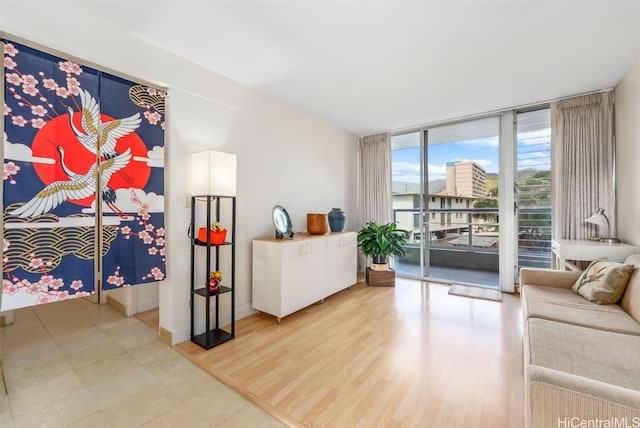 interior space with baseboards, floor to ceiling windows, and wood finished floors