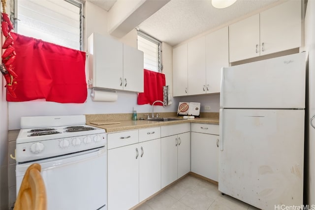 kitchen featuring light countertops, white cabinetry, a sink, a textured ceiling, and white appliances