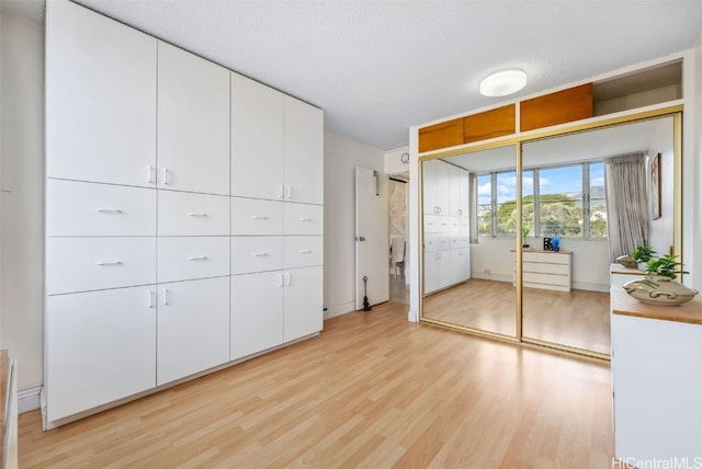 unfurnished bedroom featuring light wood-type flooring