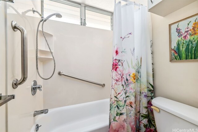 bathroom featuring toilet and shower / bath combo with shower curtain