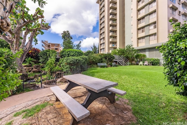 view of property's community with a lawn