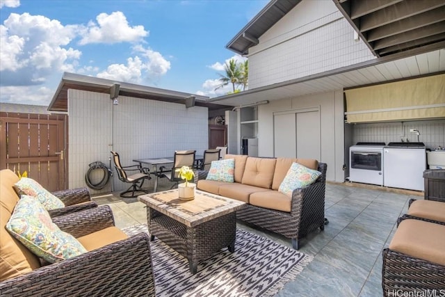 view of patio featuring outdoor lounge area and independent washer and dryer