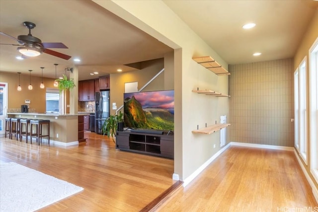 interior space featuring ceiling fan and light wood-type flooring