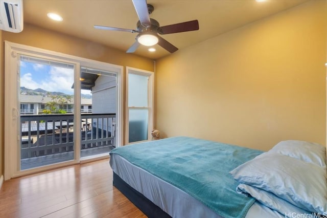 bedroom with hardwood / wood-style flooring, access to outside, and ceiling fan