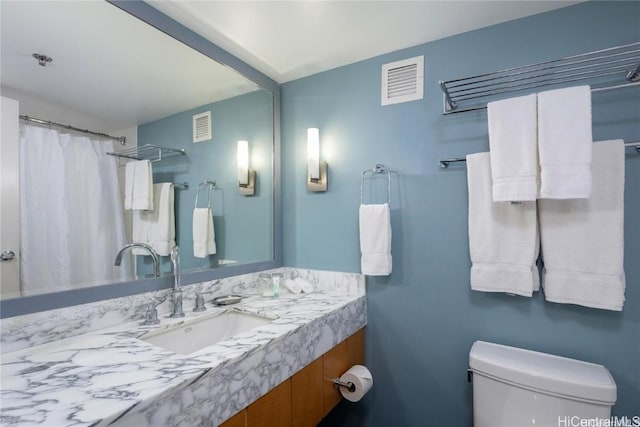 bathroom with toilet and vanity