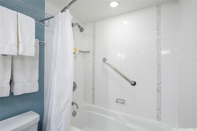 bathroom with toilet and shower / tub combo