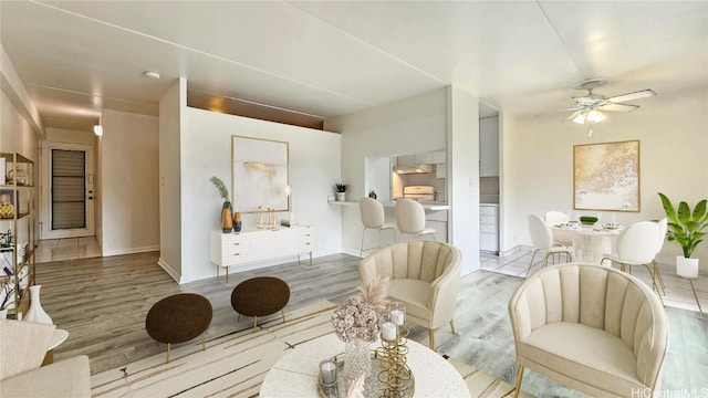 living room featuring light hardwood / wood-style flooring and ceiling fan