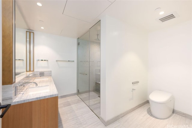 bathroom with vanity, a shower with shower door, and toilet