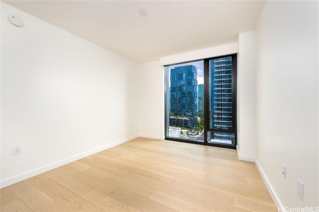 spare room with light hardwood / wood-style floors