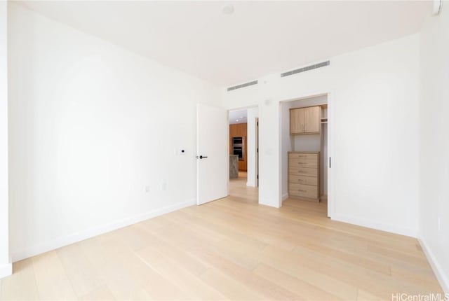 unfurnished room with light hardwood / wood-style floors