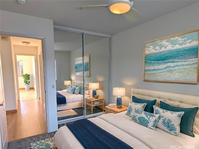 bedroom with ceiling fan, hardwood / wood-style floors, and a closet