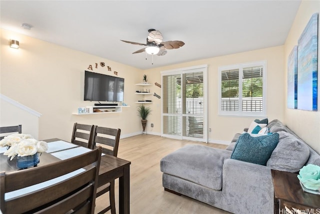 living room featuring ceiling fan and light wood-type flooring