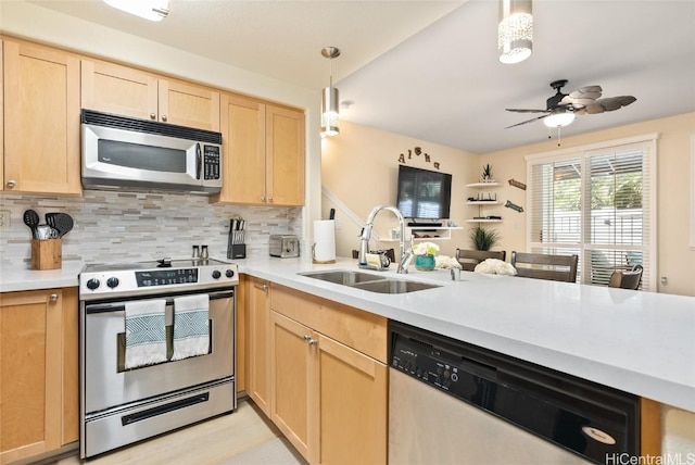 kitchen featuring appliances with stainless steel finishes, pendant lighting, light brown cabinetry, sink, and backsplash