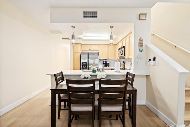 dining space featuring light hardwood / wood-style floors