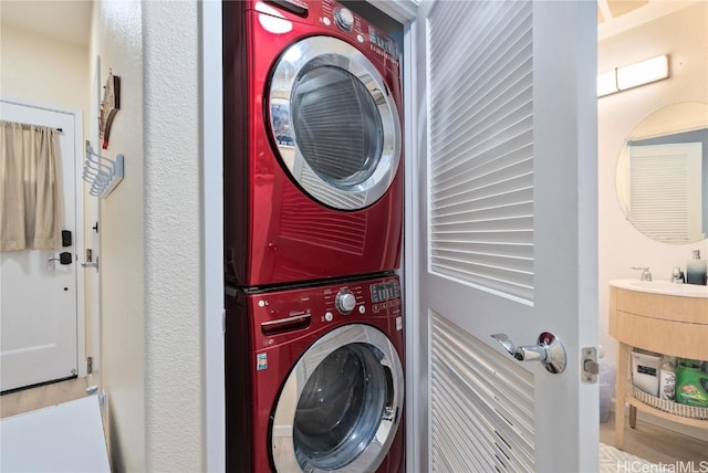 laundry area featuring stacked washer and clothes dryer