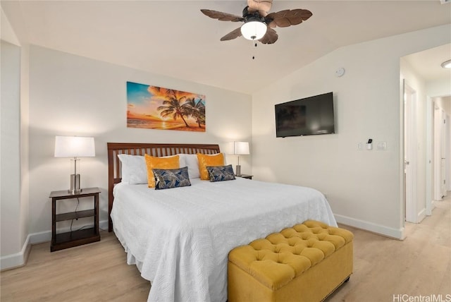 bedroom with ceiling fan, vaulted ceiling, and light wood-type flooring