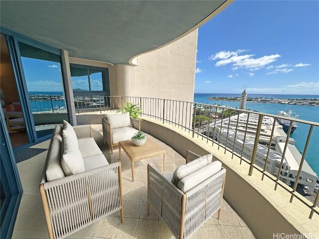 balcony featuring an outdoor living space and a water view