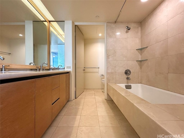 full bathroom featuring tiled shower / bath combo, toilet, tile patterned flooring, and vanity