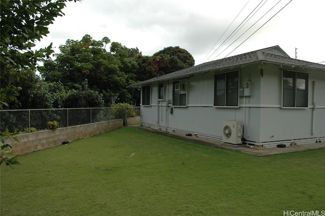 view of side of home featuring a yard and ac unit