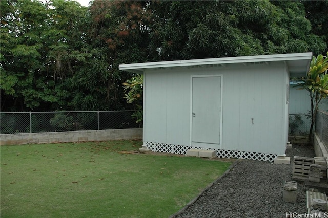 view of outbuilding featuring a lawn