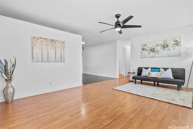 living room featuring wood-type flooring and ceiling fan