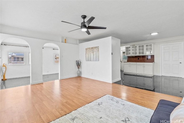 living room with ceiling fan and wood-type flooring