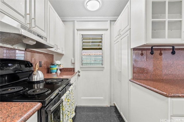 kitchen featuring black electric range oven, decorative backsplash, and white cabinets