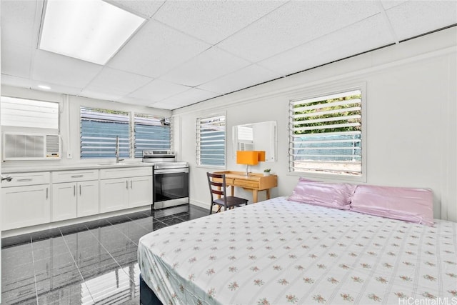 bedroom featuring sink and a drop ceiling