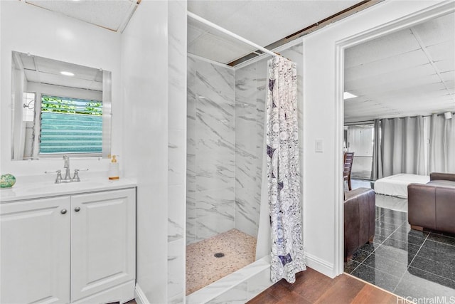 bathroom with hardwood / wood-style floors, vanity, and curtained shower