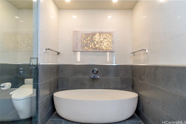 bathroom featuring tile walls, tile patterned flooring, toilet, and walk in shower