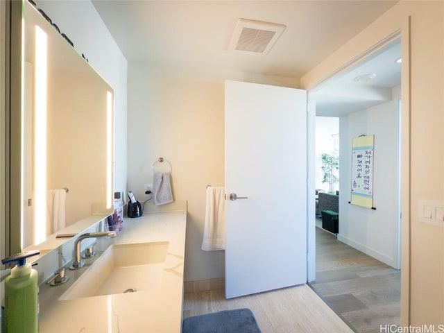 bathroom with hardwood / wood-style floors and sink