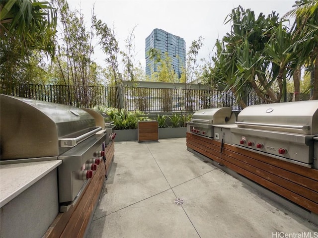 view of patio / terrace featuring an outdoor kitchen and a grill