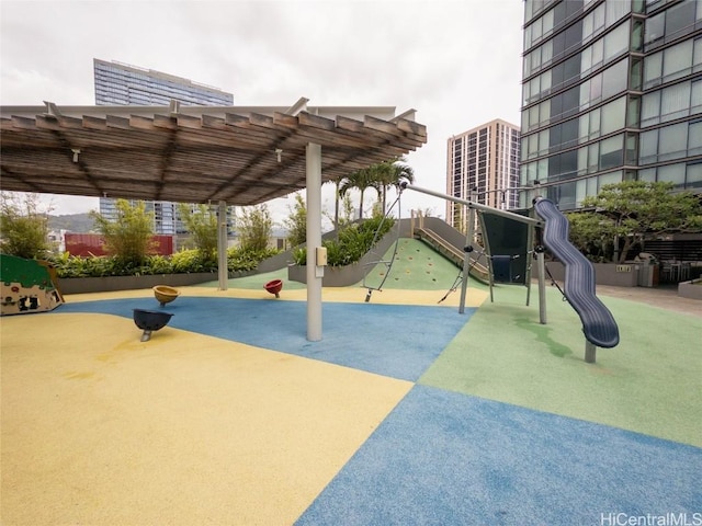 view of community featuring a playground and a pergola