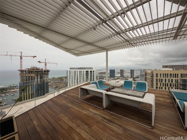 wooden terrace featuring a water view and a pergola