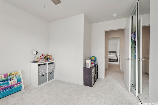 recreation room featuring ceiling fan and light carpet