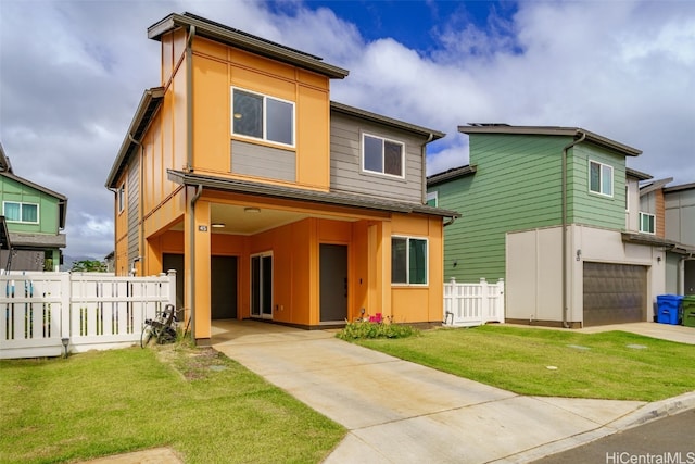 rear view of property featuring a yard and a garage