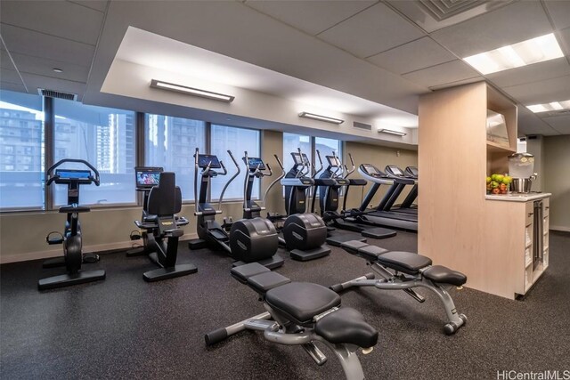 gym featuring a drop ceiling