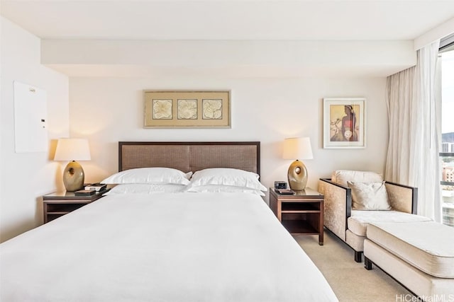 bedroom featuring electric panel and light carpet