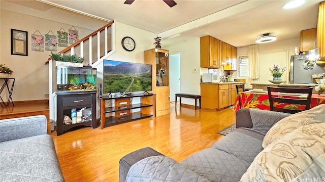 living room with ceiling fan and light hardwood / wood-style floors