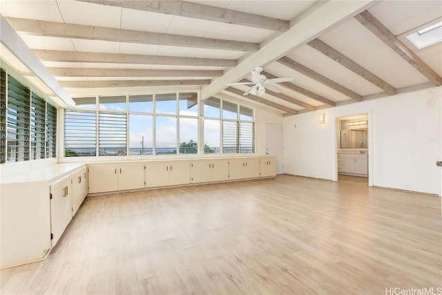 interior space with ceiling fan and lofted ceiling with beams