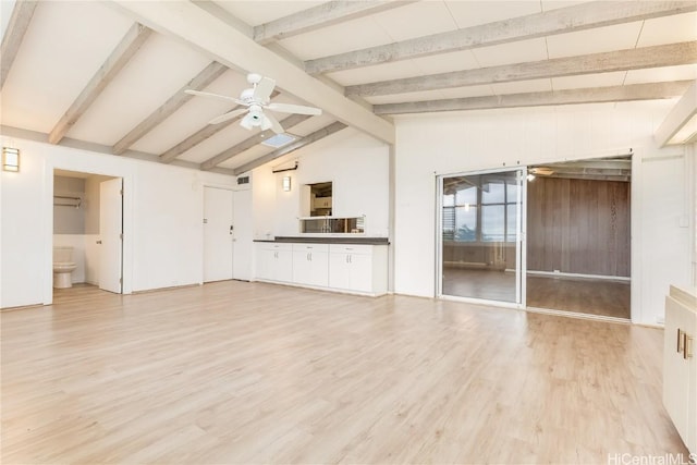 unfurnished living room featuring ceiling fan, lofted ceiling with beams, and light wood-type flooring