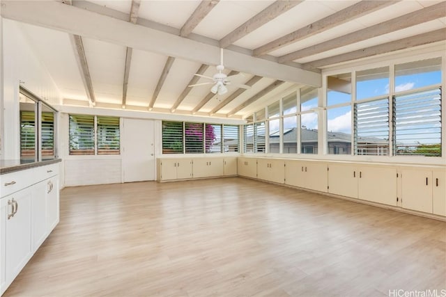 unfurnished sunroom featuring lofted ceiling with beams and ceiling fan