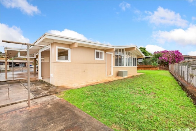 rear view of property with a yard and a patio area