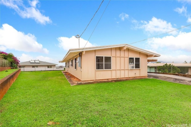 rear view of property featuring a yard