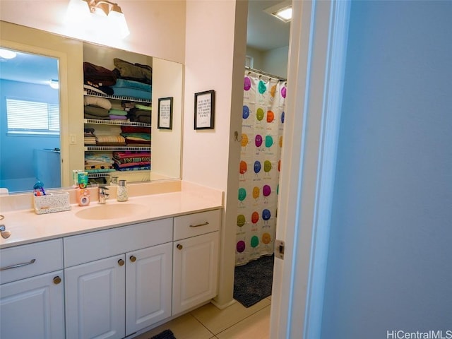 bathroom featuring vanity, tile patterned floors, and walk in shower