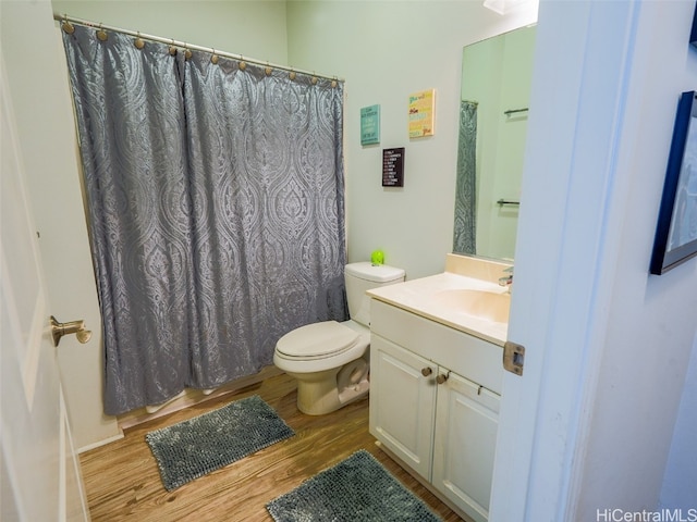 bathroom with vanity, hardwood / wood-style floors, and toilet