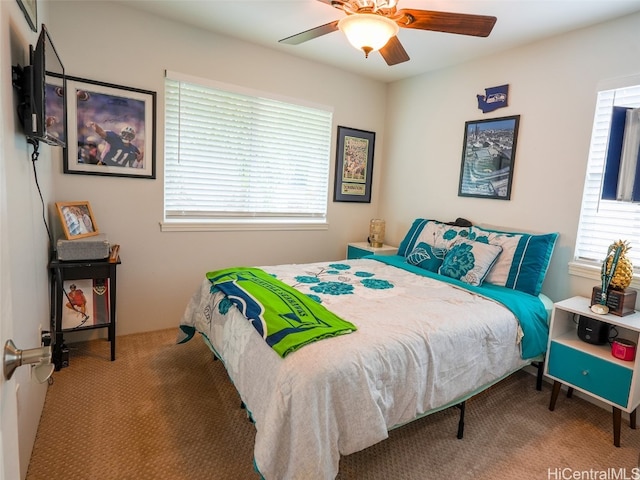 bedroom featuring ceiling fan and carpet