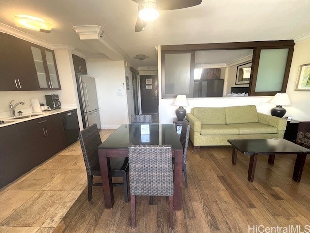 dining area featuring crown molding, wood-type flooring, sink, and ceiling fan