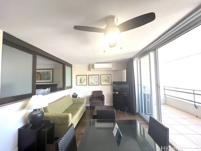 living room featuring a wall mounted air conditioner and ceiling fan