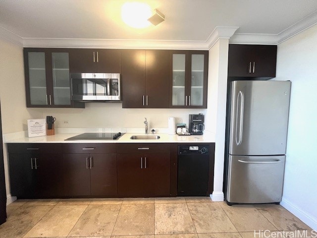 kitchen featuring dark brown cabinetry, sink, crown molding, light tile patterned floors, and black appliances